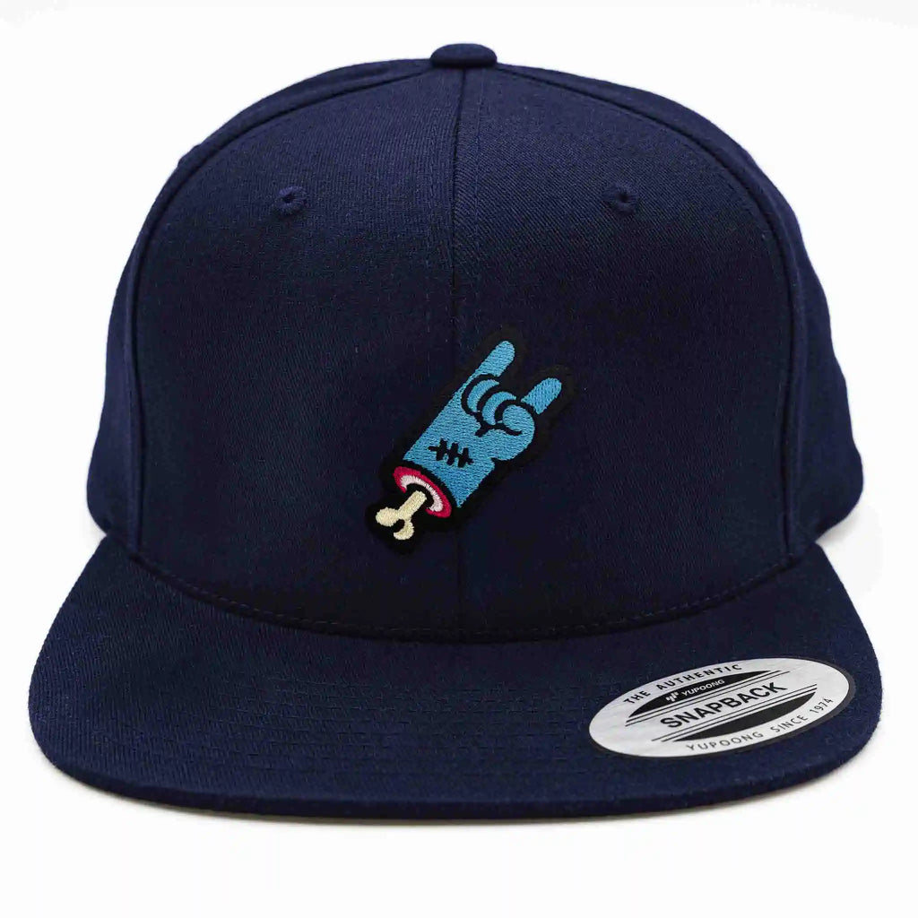 Jeune homme et femme portant des casquettes Flexfit noires avec système velcro et écussons interchangeables devant un food truck. Casquette personnalisée avec design unique, disponible aussi en version porte-crayons pratique.