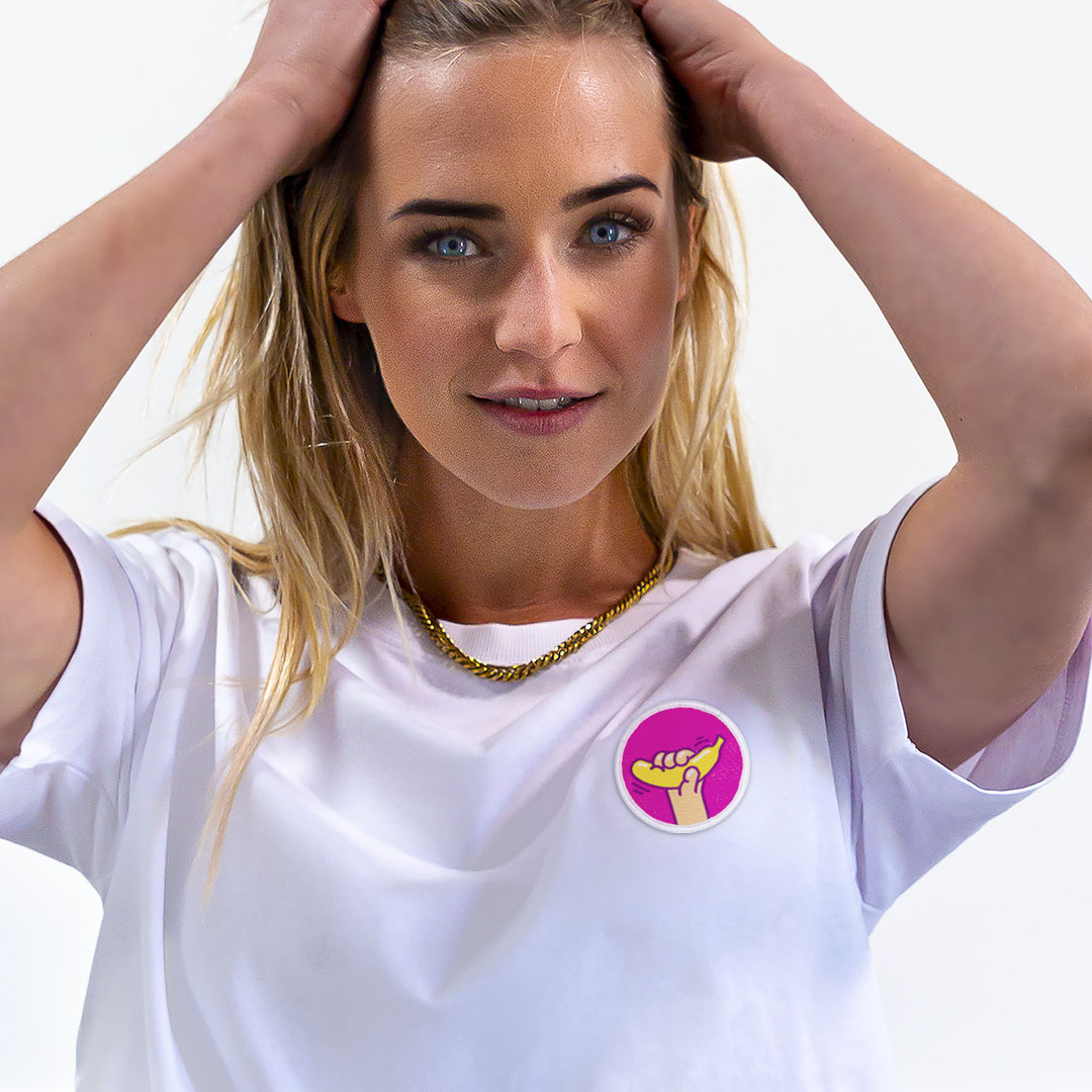 Femme avec les mains dans les cheveux portant un super t-shirt en coton bio avec un écusson banane